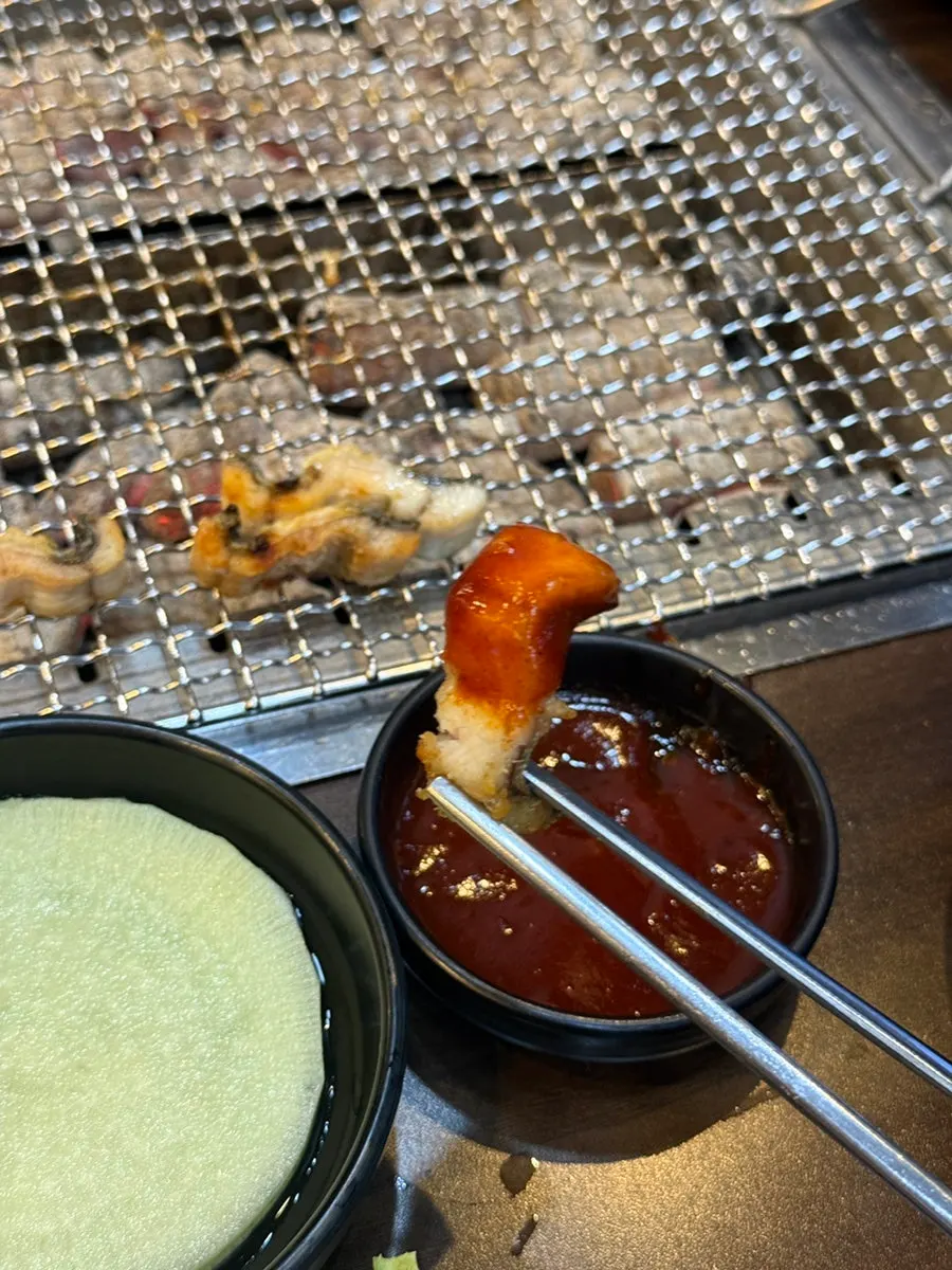 Pre-grilled eel being finished over charcoal