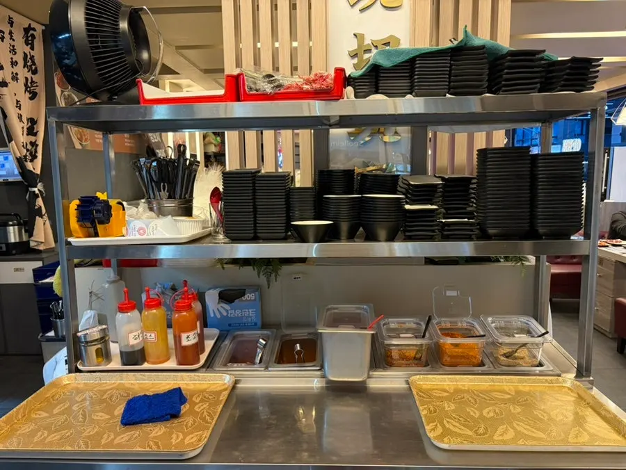 Self-serve bar with sauces and side dishes