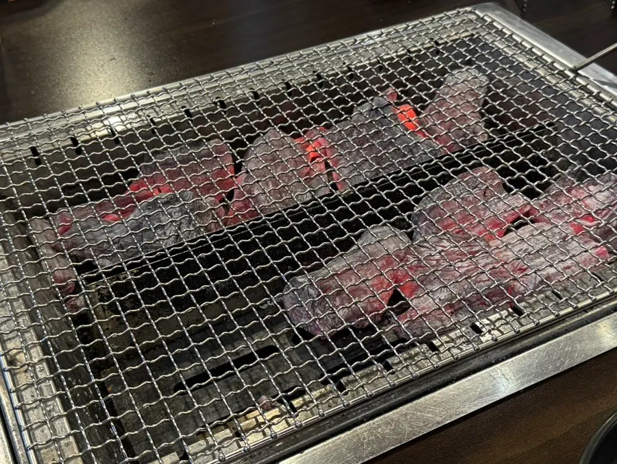 Charcoal grill set up with one side left empty for grilling eel
