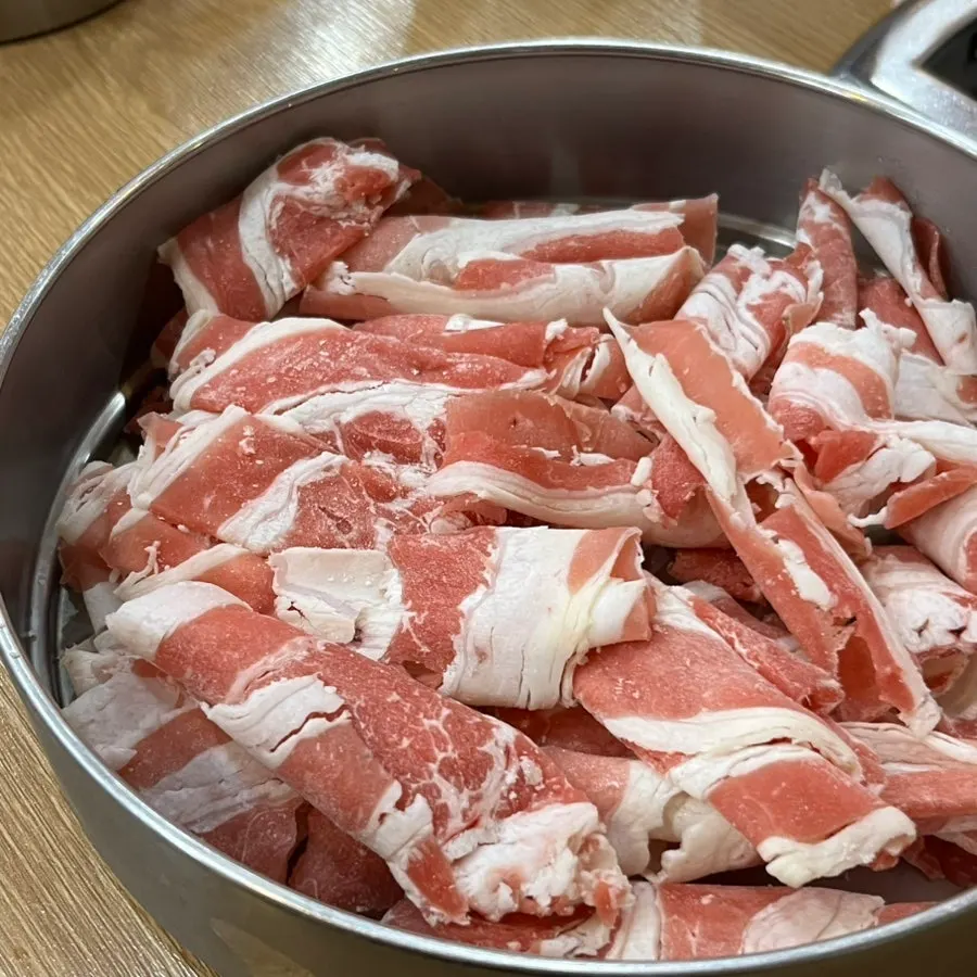 Pot of usintang hot pot filled with mushrooms, vegetables, and short ribs
