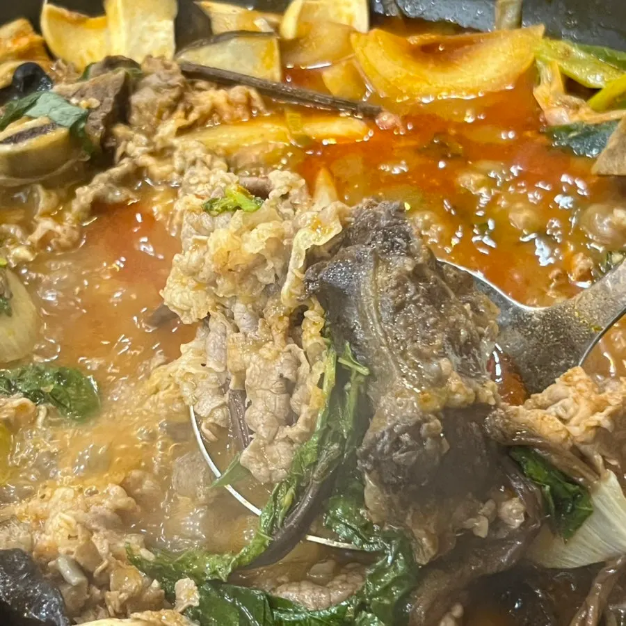 Full table spread with pot rice and hot pot together