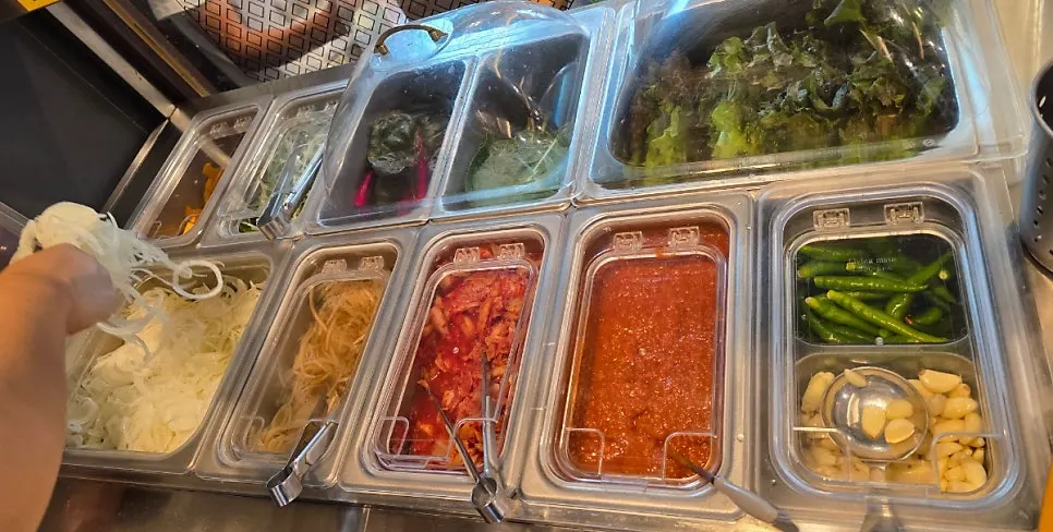 A spread of side dishes including seasoned crab and pickled onions