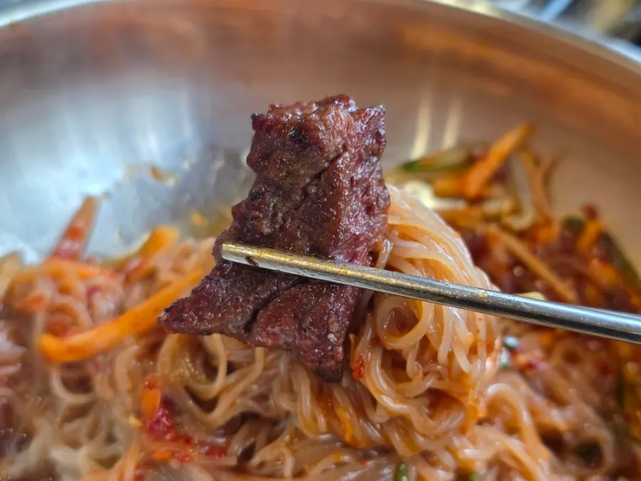 A grilled piece of galbi paired with pickled onions