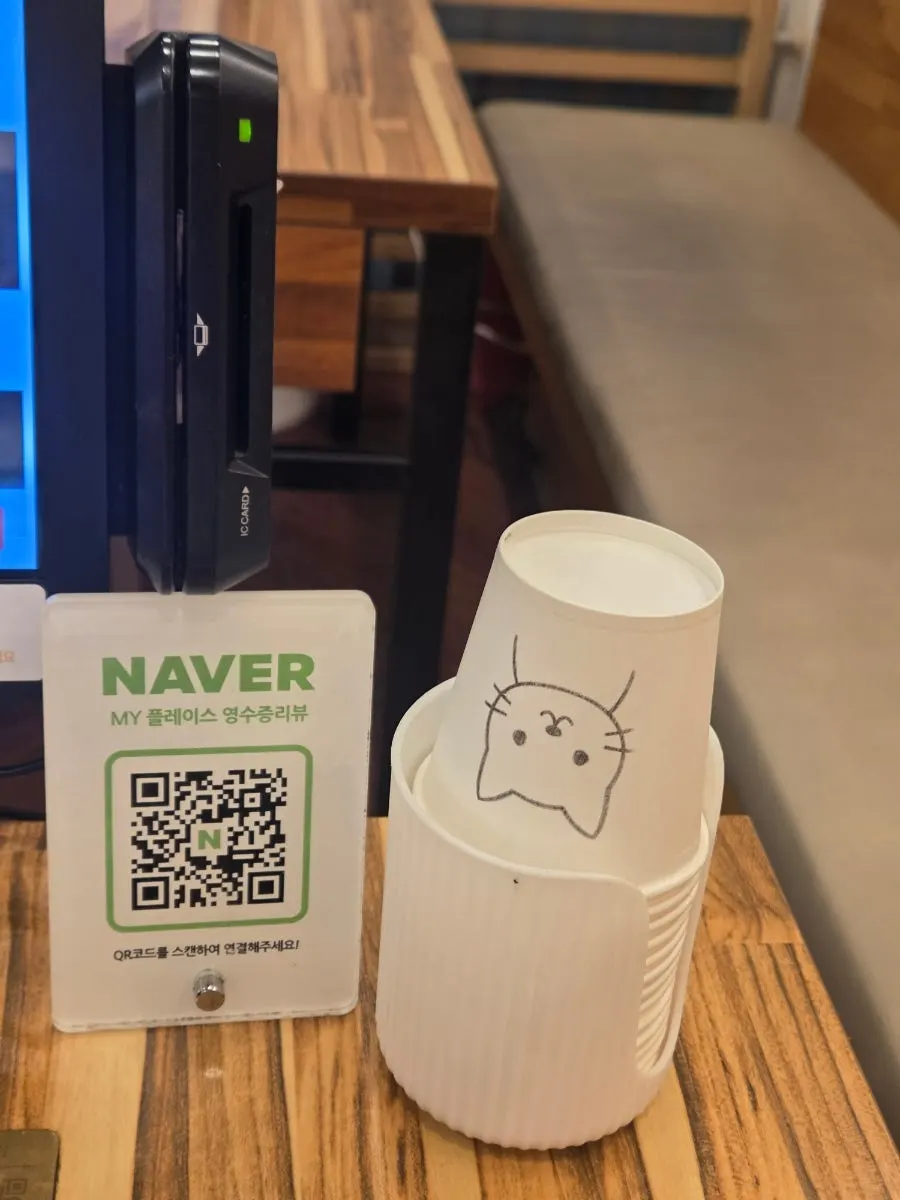 Water poured into a paper cup with a cute illustration