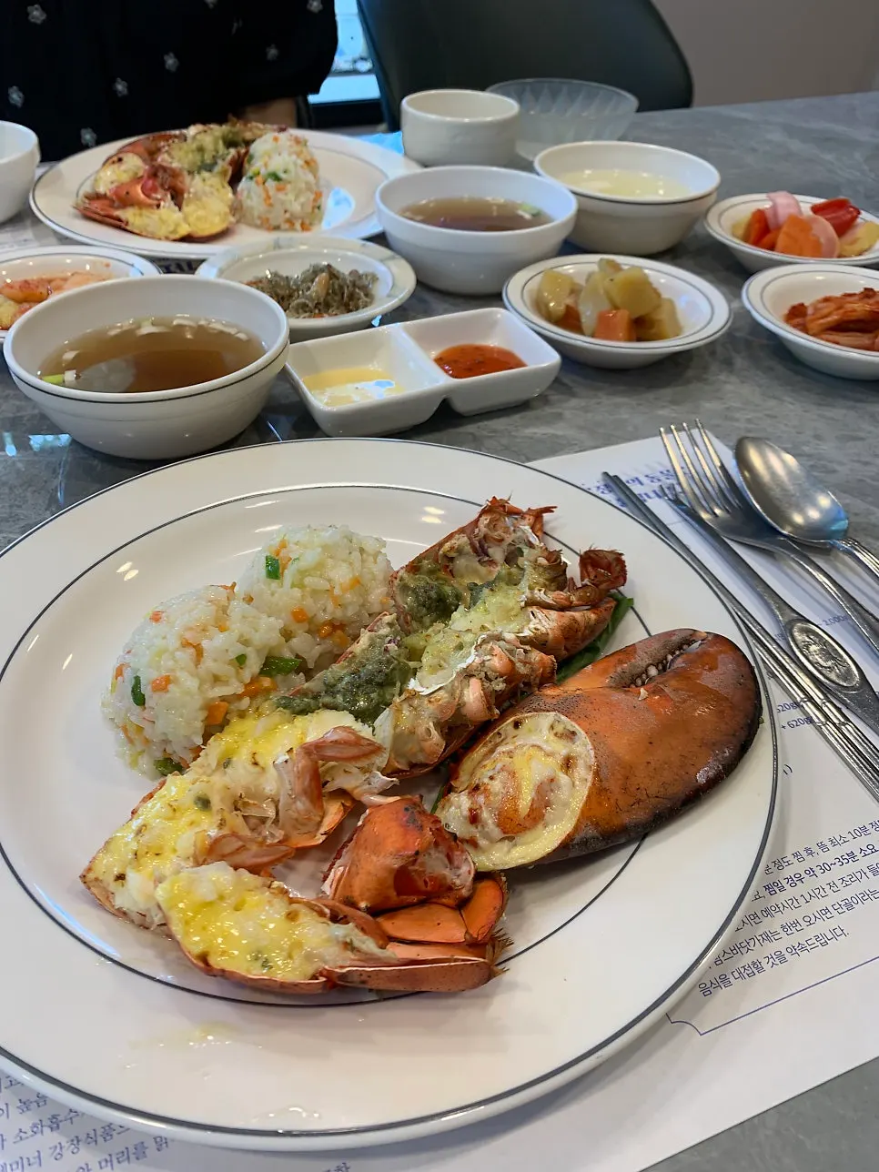 Half a seasoned grilled lobster and lobster soup
