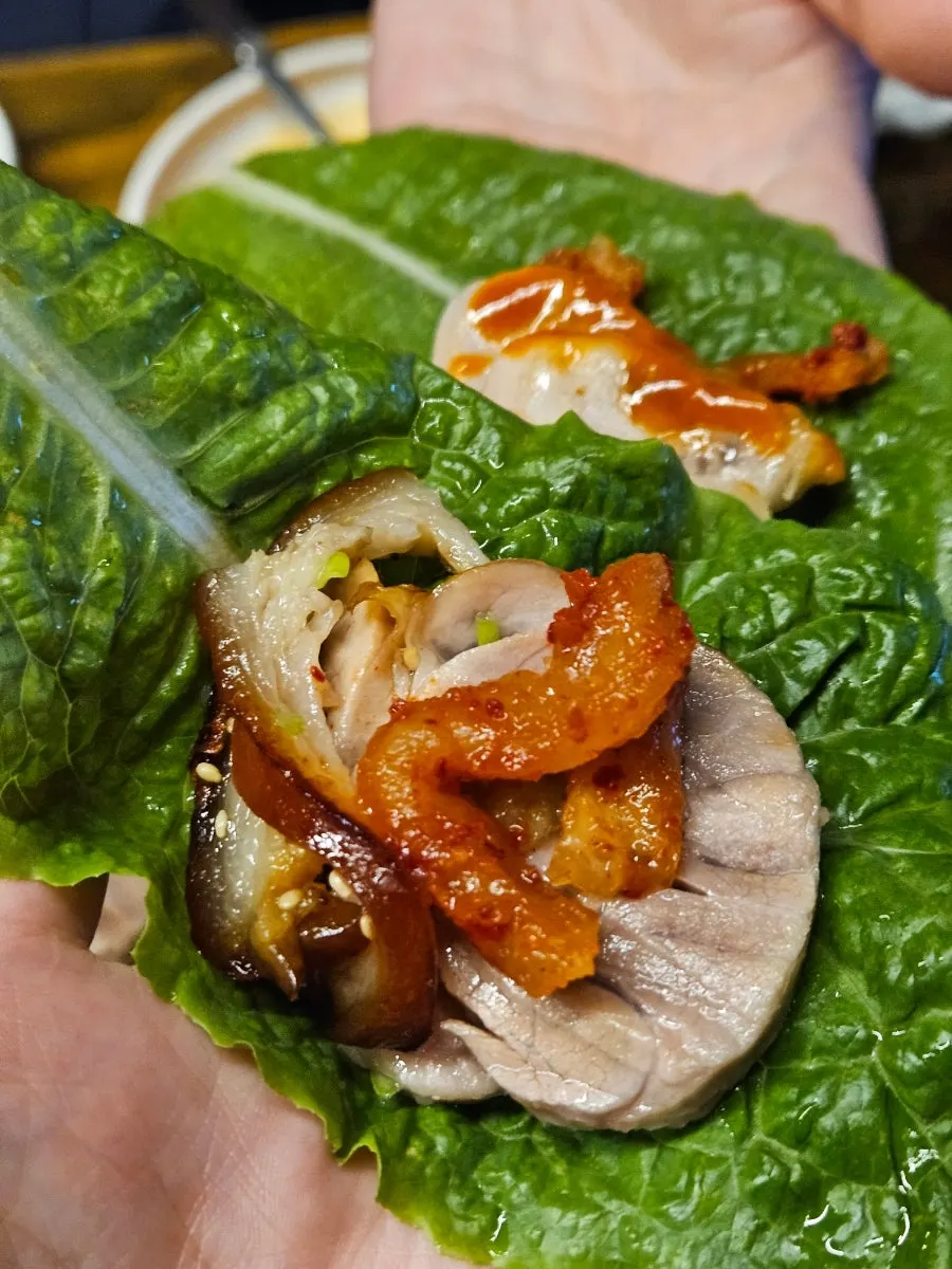 A piece of wood-fired trotter placed on pickled radish