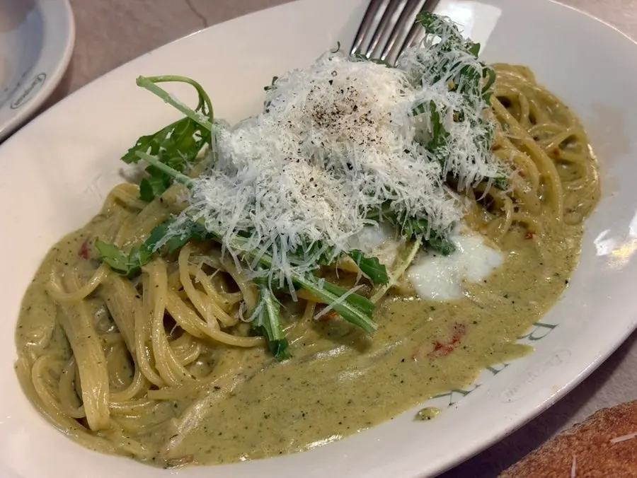 Basil pesto cream pasta with a poached egg