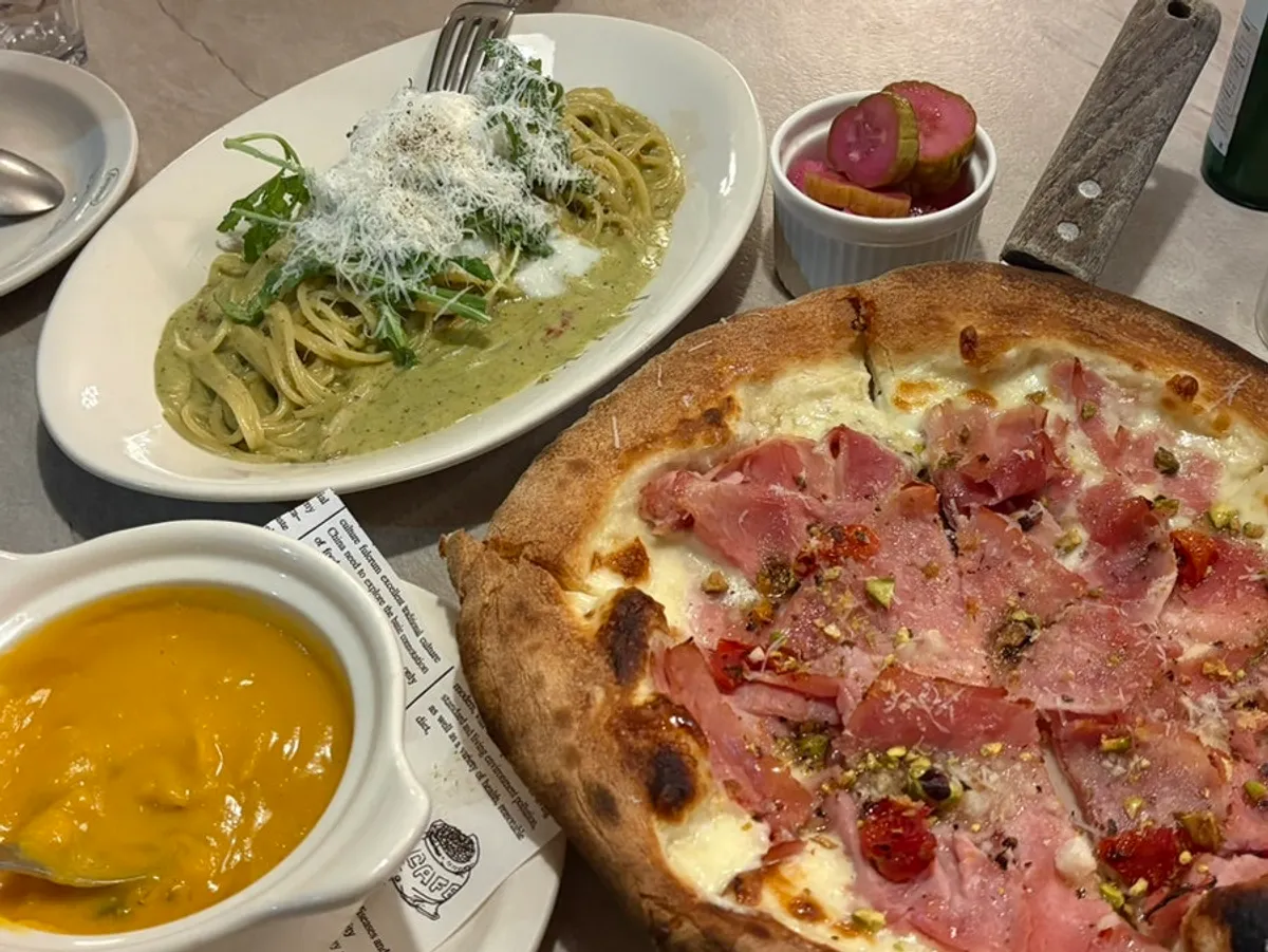 A full spread of soup, pizza, and pasta