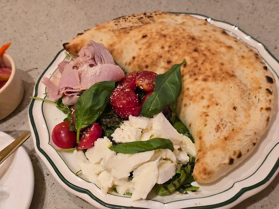 Basil calzone baked in a half-moon shape