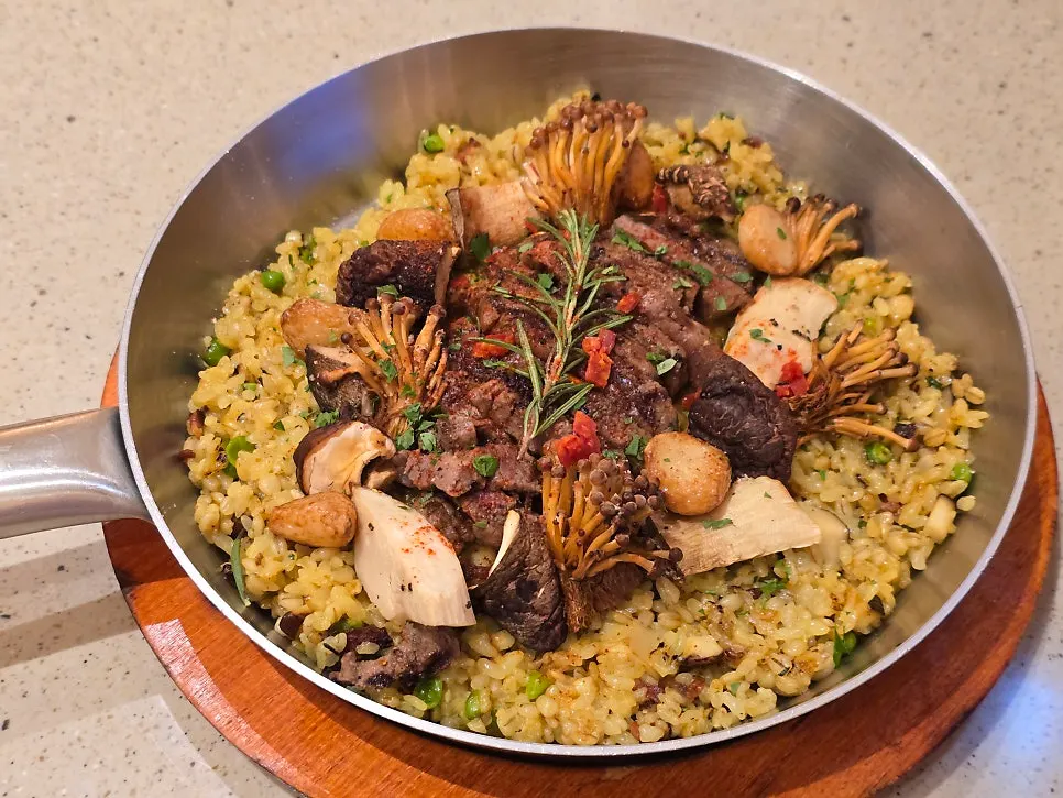 Hanwoo steak mushroom paella served in the pan