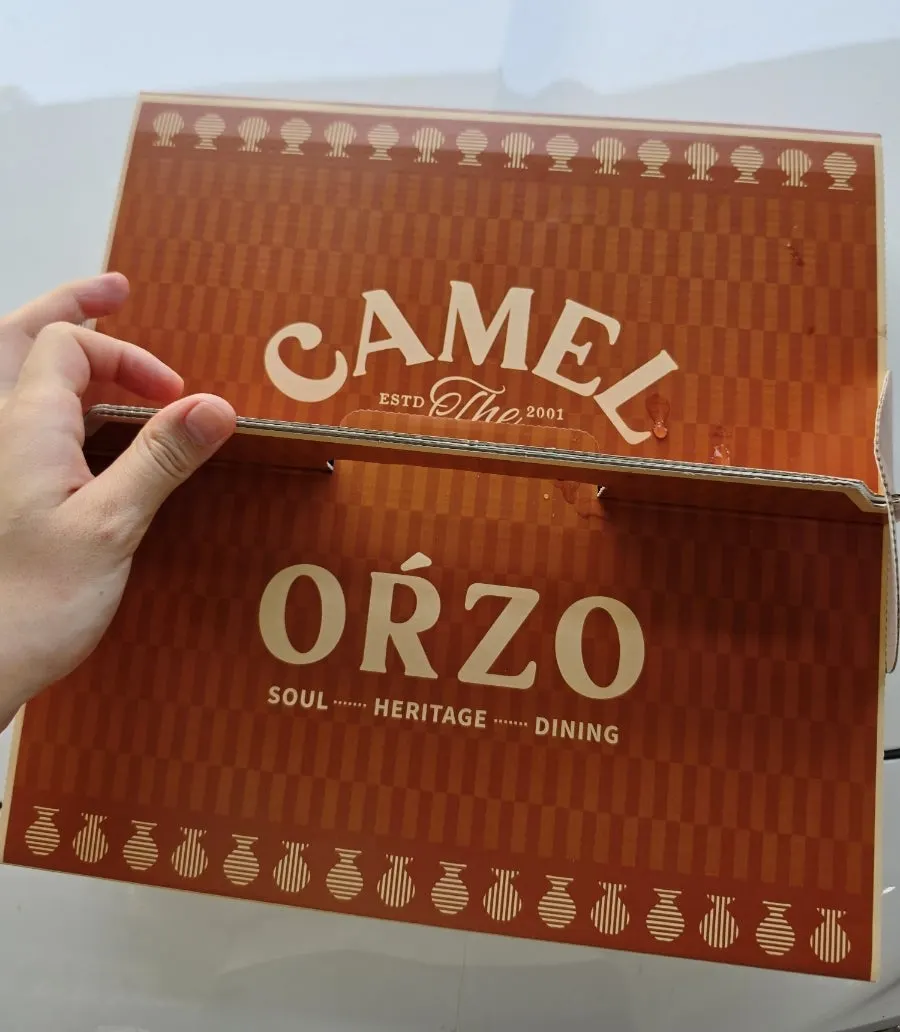 A takeout box with the leftover pizza