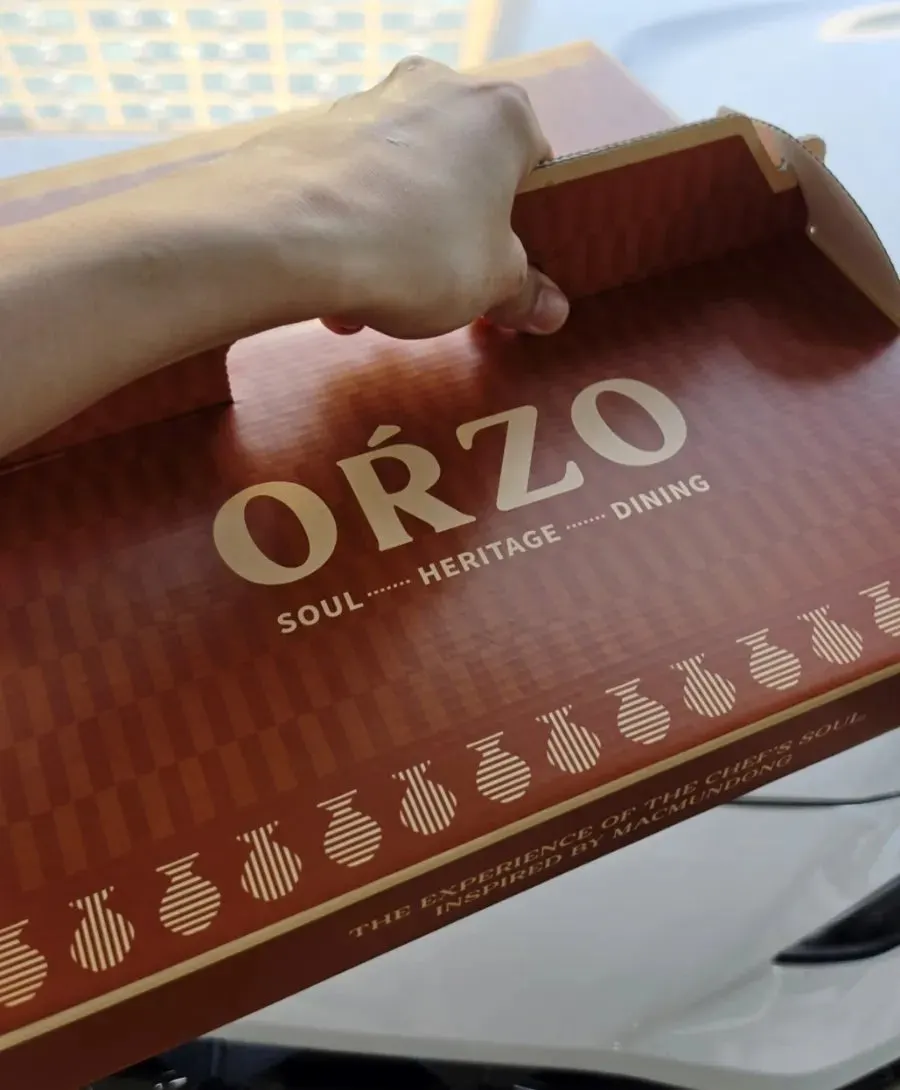 A takeout bag with the pistachio sauce included