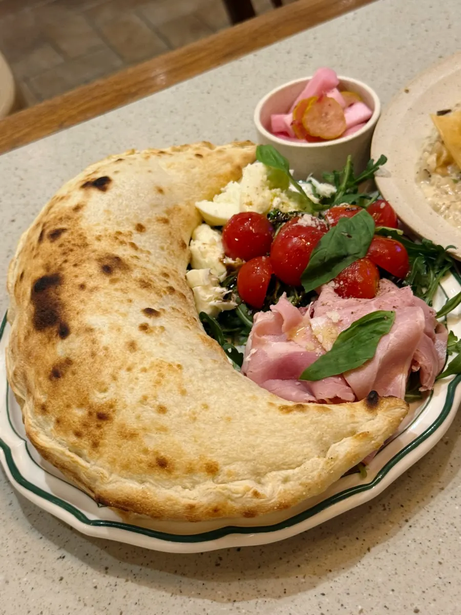 Basil calzone folded in half and baked