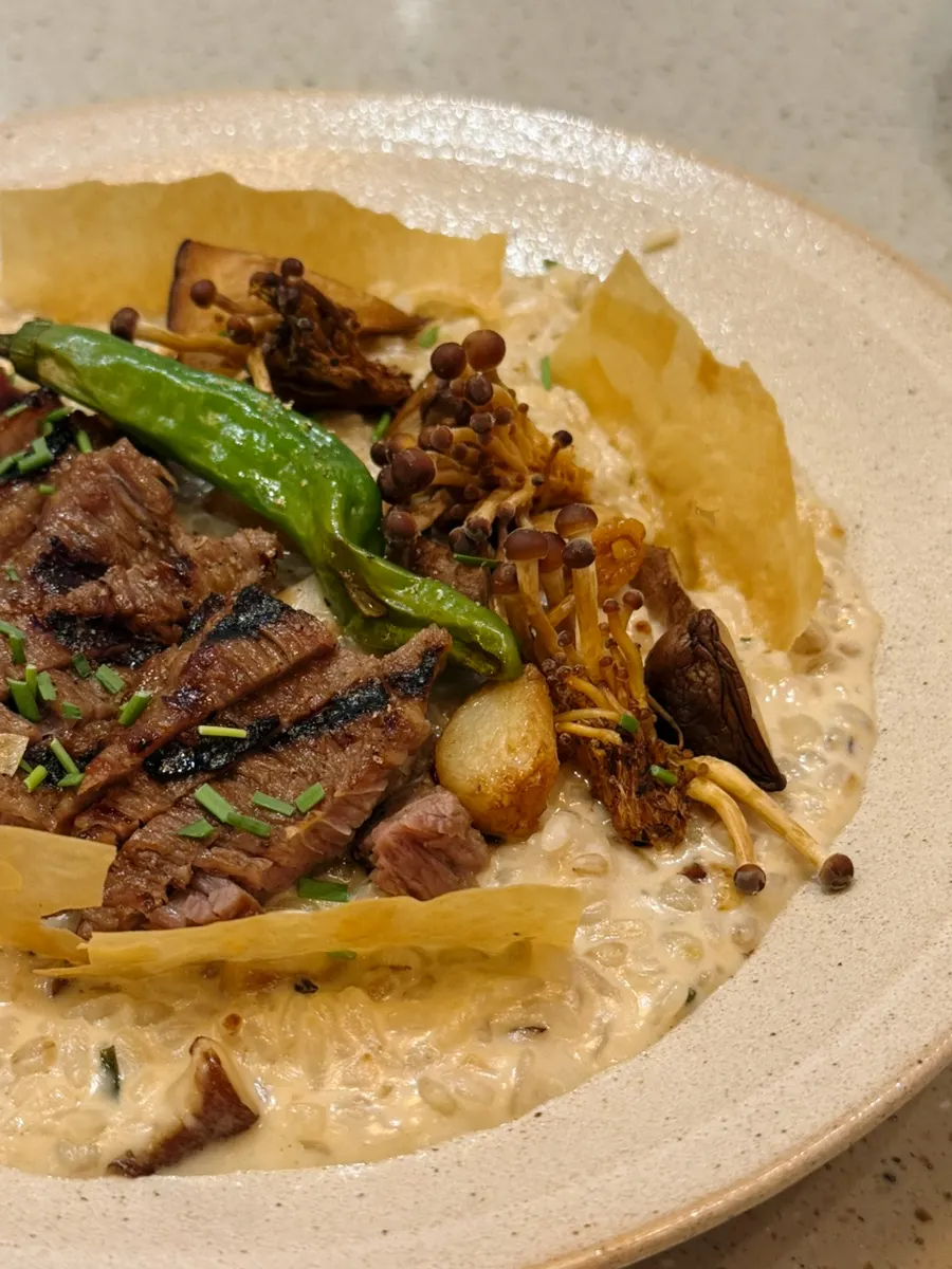 A spoonful of risotto with grilled mushroom and chip