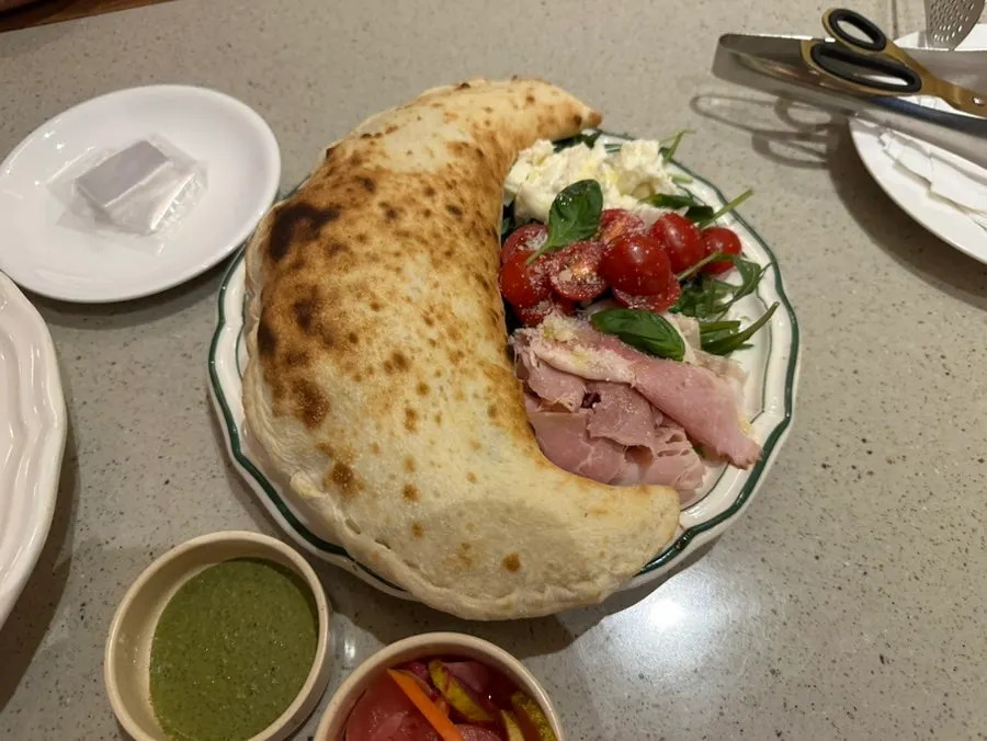 Basil calzone and cuttlefish aglio pasta order