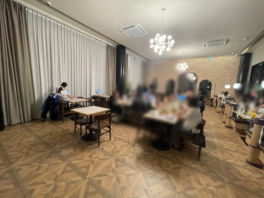Dining hall tables spaced widely apart