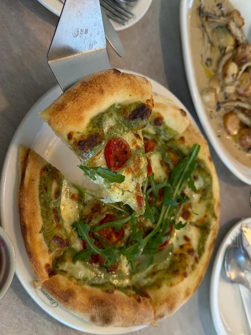 A slice of margherita pizza with stretchy cheese