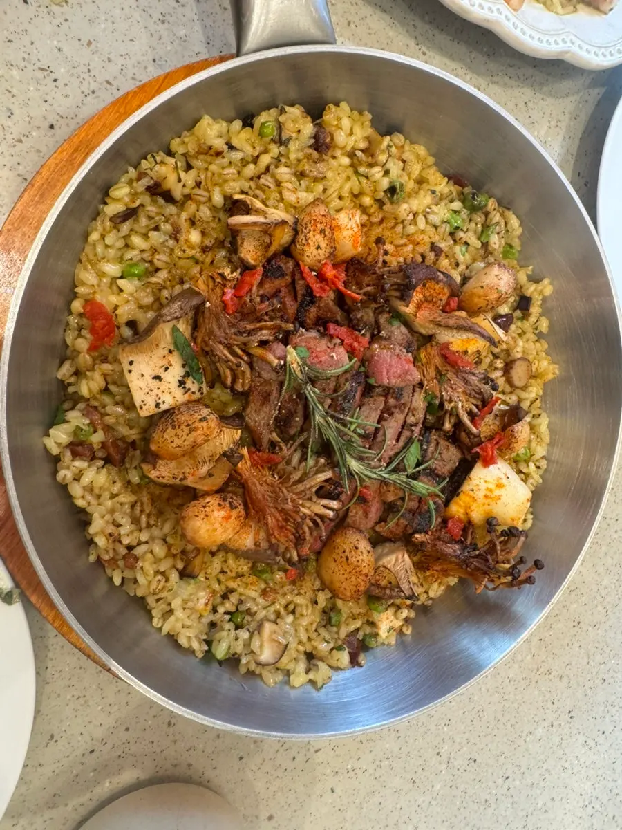 Paella topped with beef and king oyster mushrooms