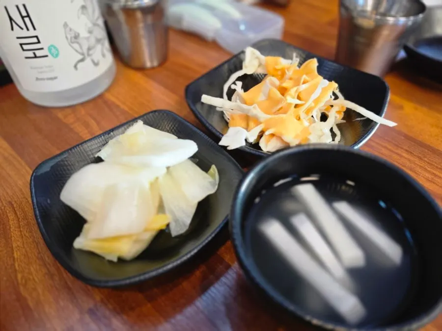 Dongchimi radish water kimchi, baek-kimchi, and salad side dishes