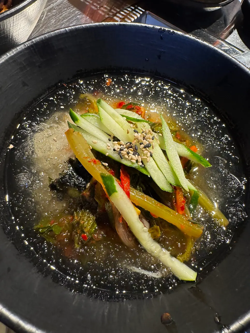 Yeolmu mani guksu served alongside grilled eel