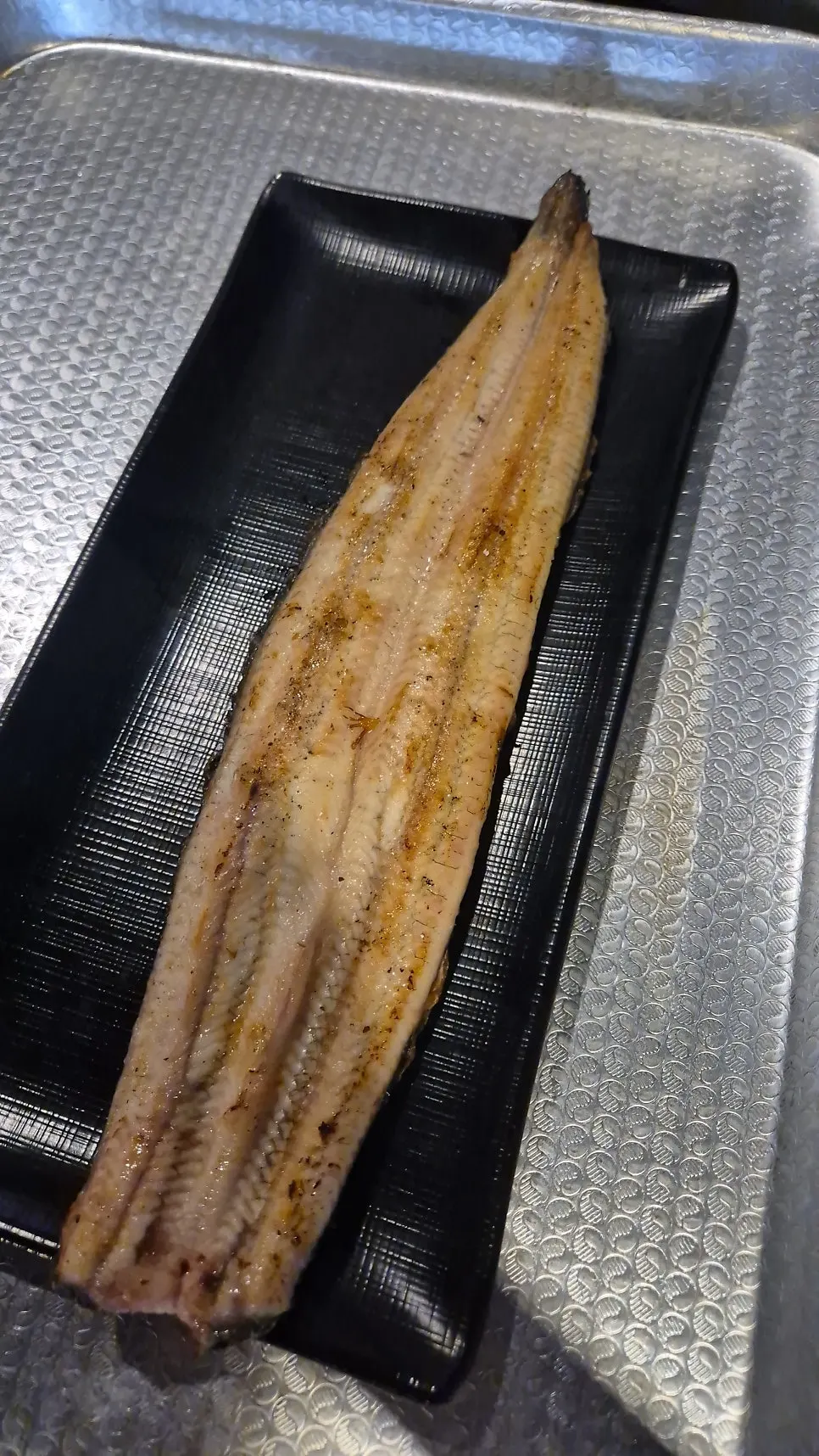 Eel cooking on the charcoal grill