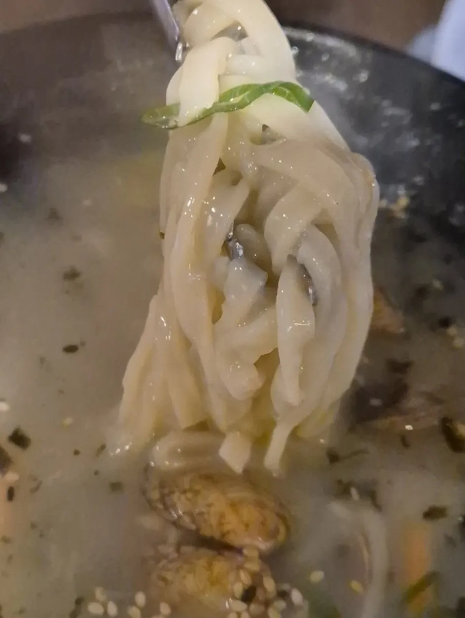 A spoonful of rice mixed into eel soup