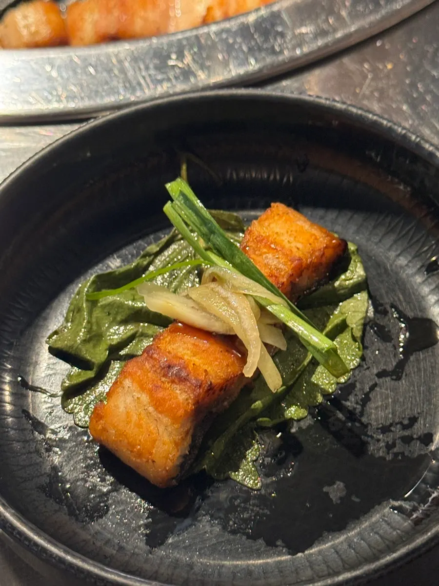 Grilled eel on preserved perilla leaf with pickled onion & chive