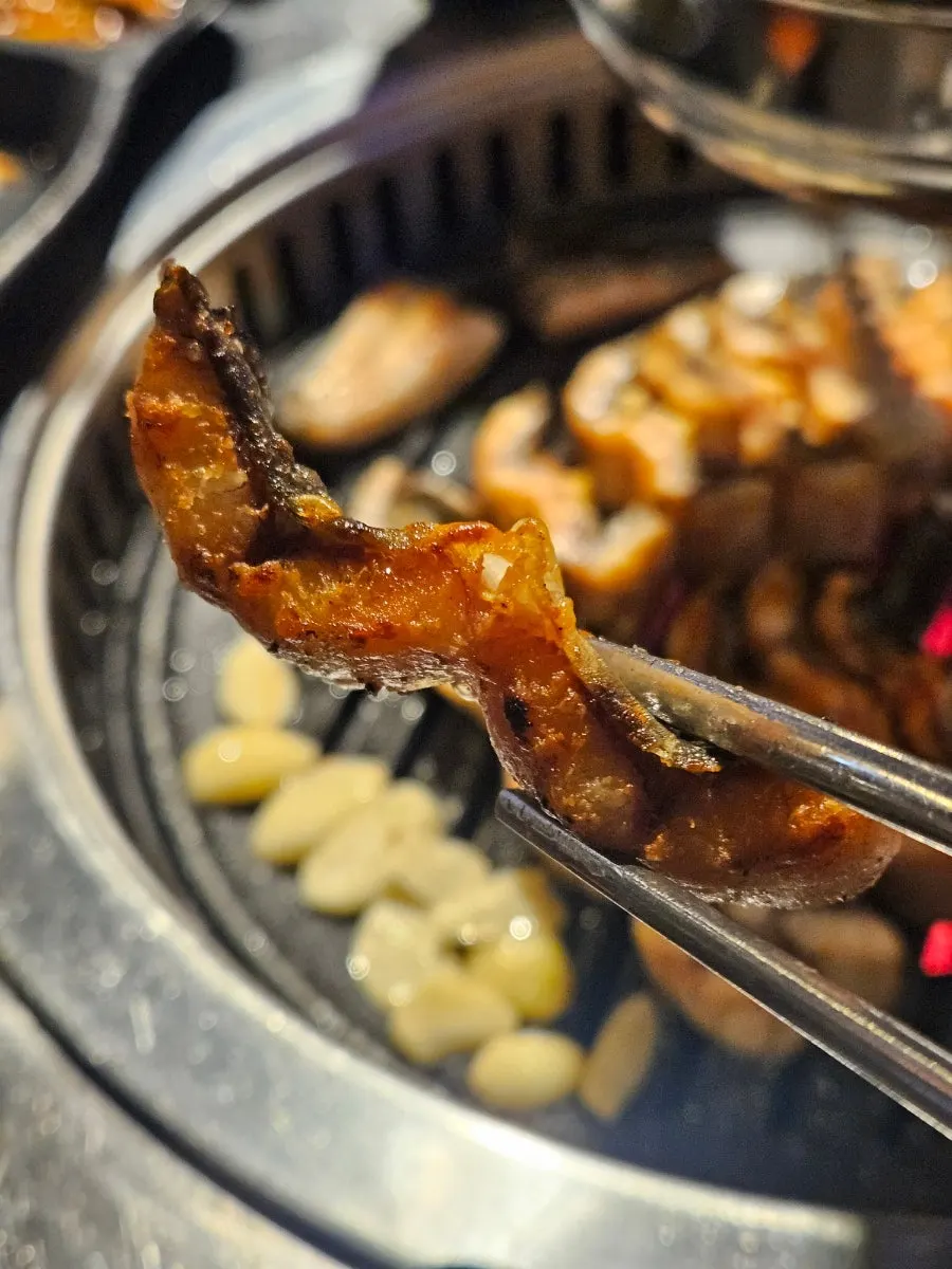 Picking up a springy piece of grilled eel