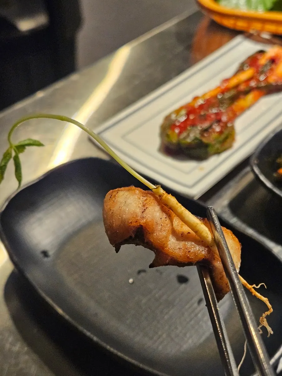 A piece of eel dipped in the soy-wasabi sauce