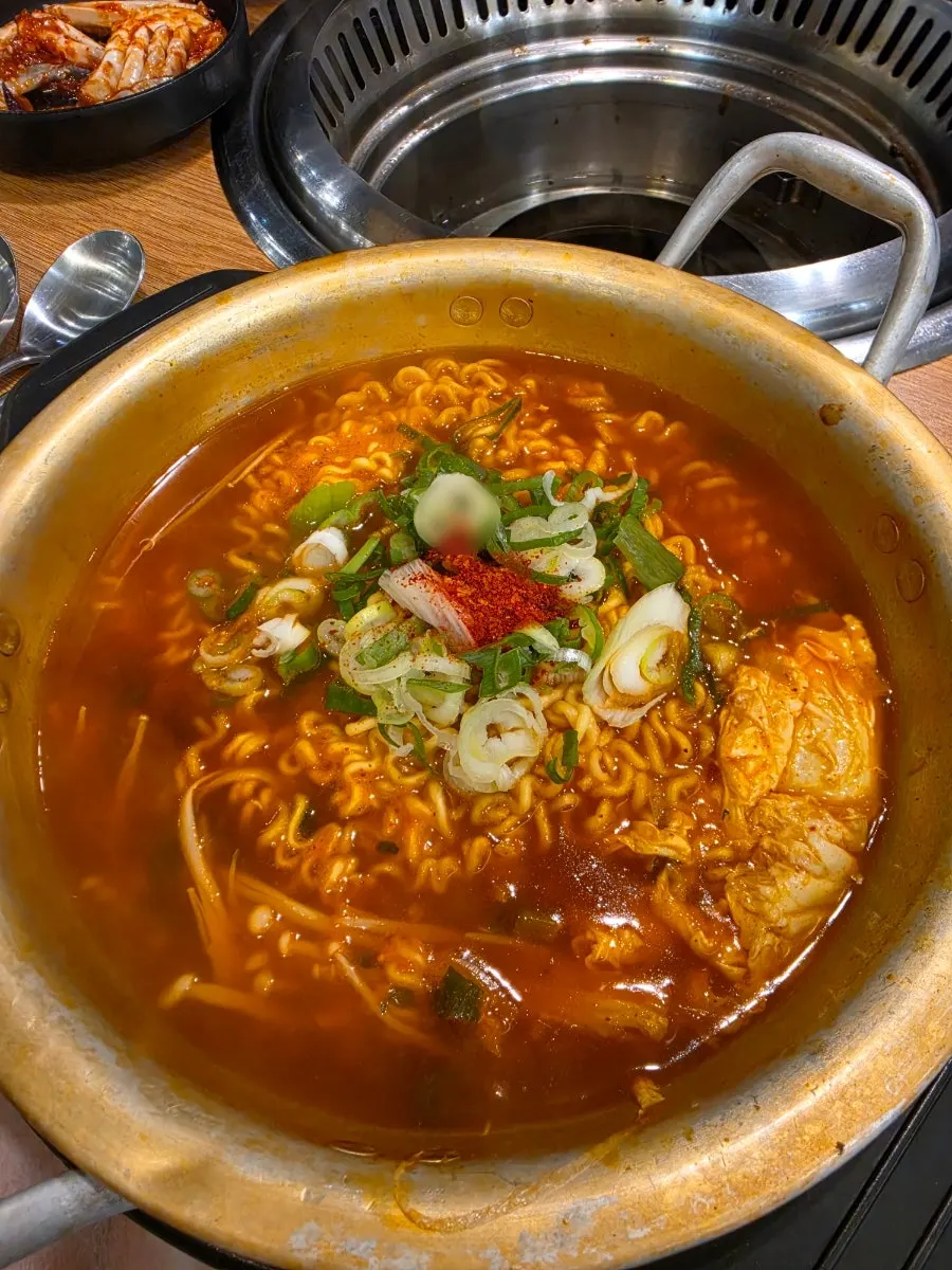 Spicy hangover ramen served boiling in a pot