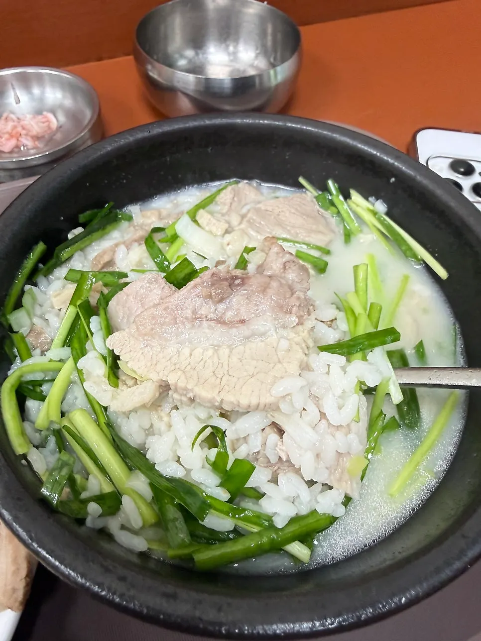 A bowl of pork gukbap with rice served separately