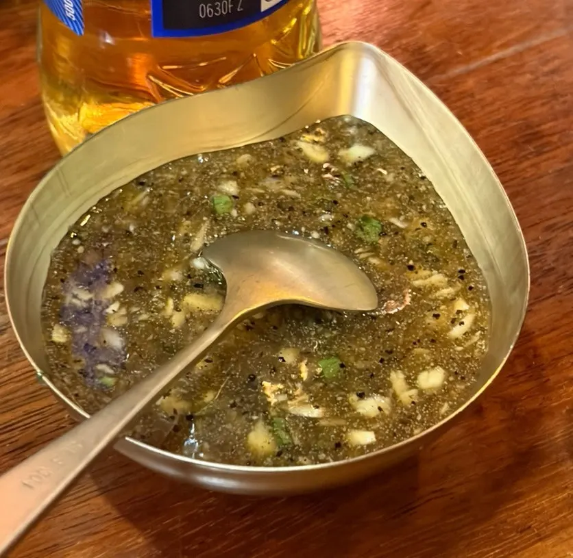 A full spread of Goheung raw garlic jokbal grilled once more over charcoal