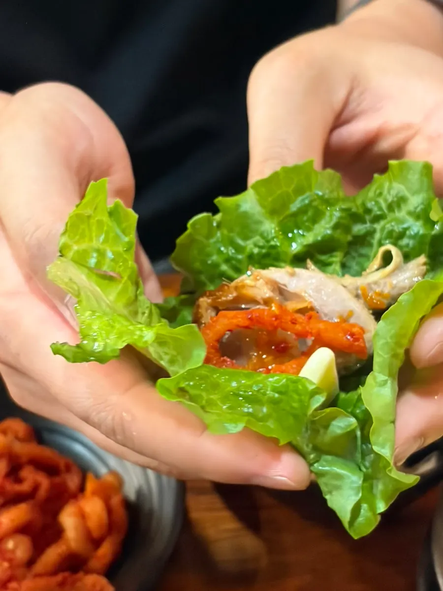 Close-up of jokbal drizzled with raw garlic sauce
