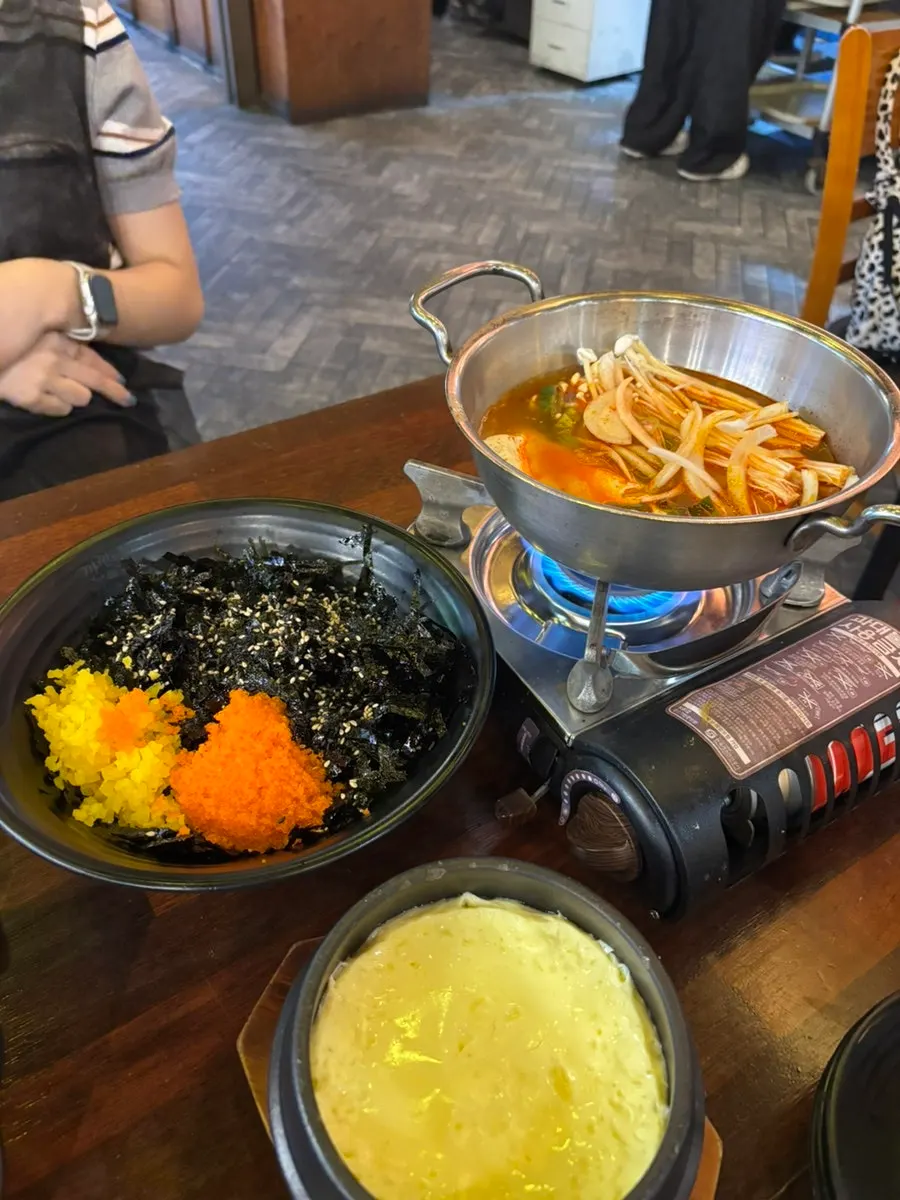 Sundubu jjigae, steamed egg, and flying fish roe rice balls served as basics
