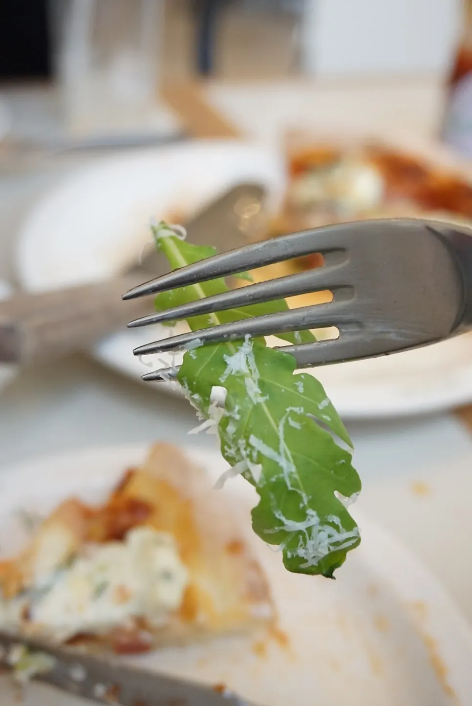A slice of the arugula pizza