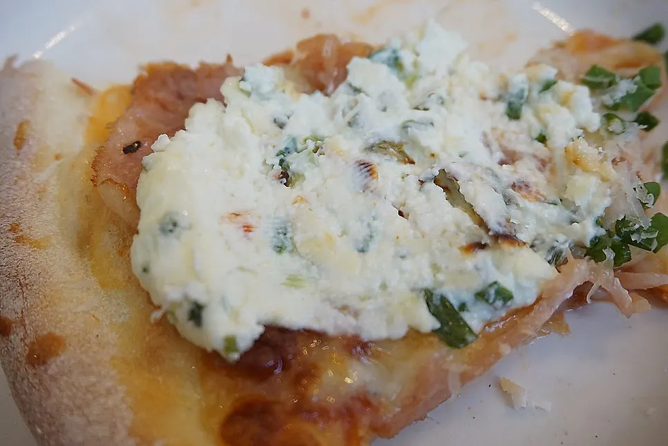 Pemanong Jambon pizza topped with green onion spread