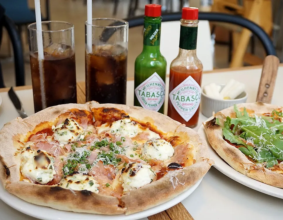 Both pizzas placed together on the table