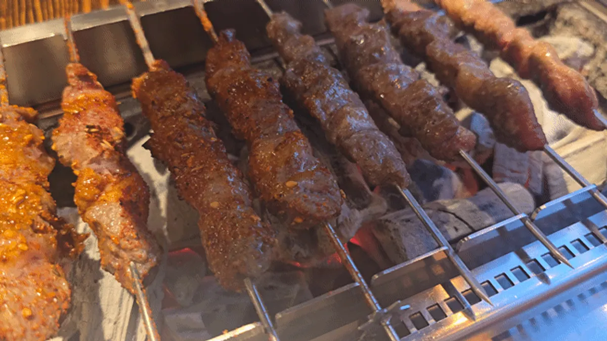 Lamb skewers grilling on the rotating grill