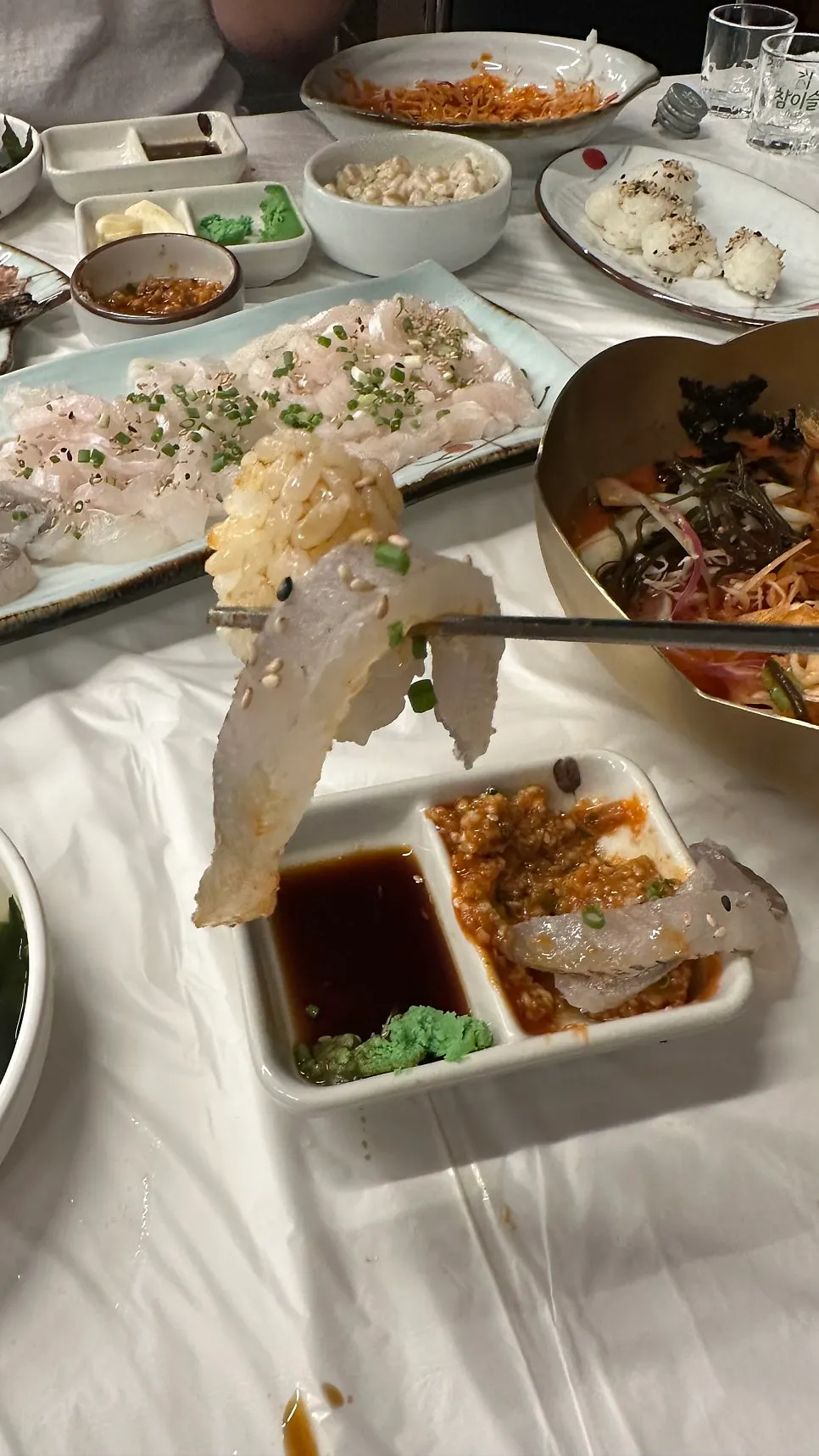 Live fish sashimi eaten with dipping sauce