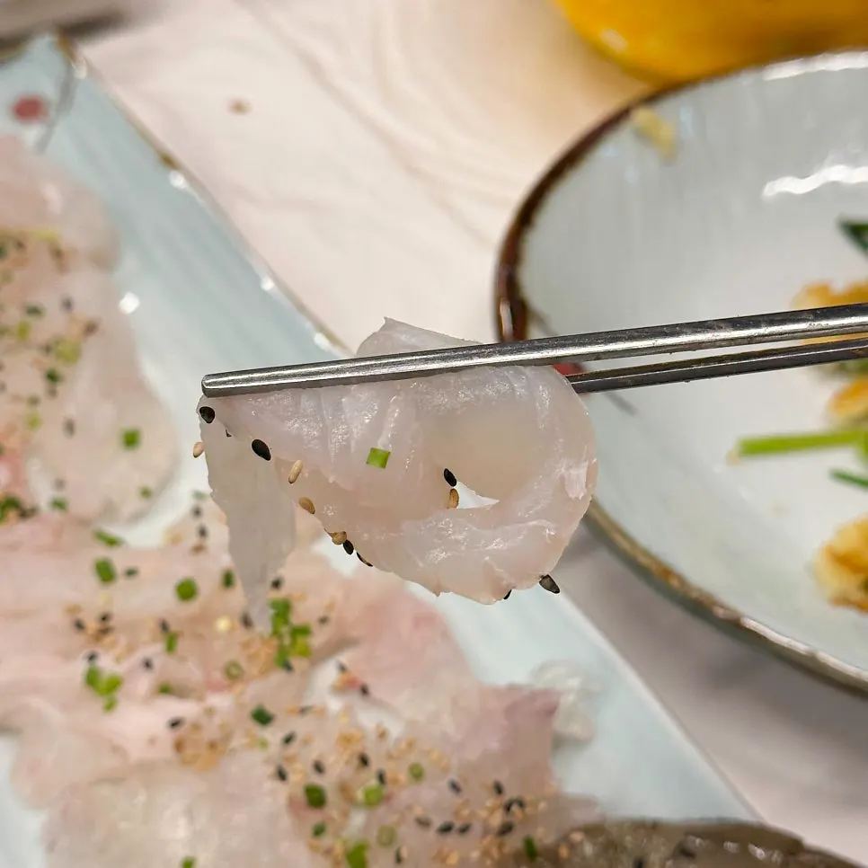 A piece of sashimi with soju