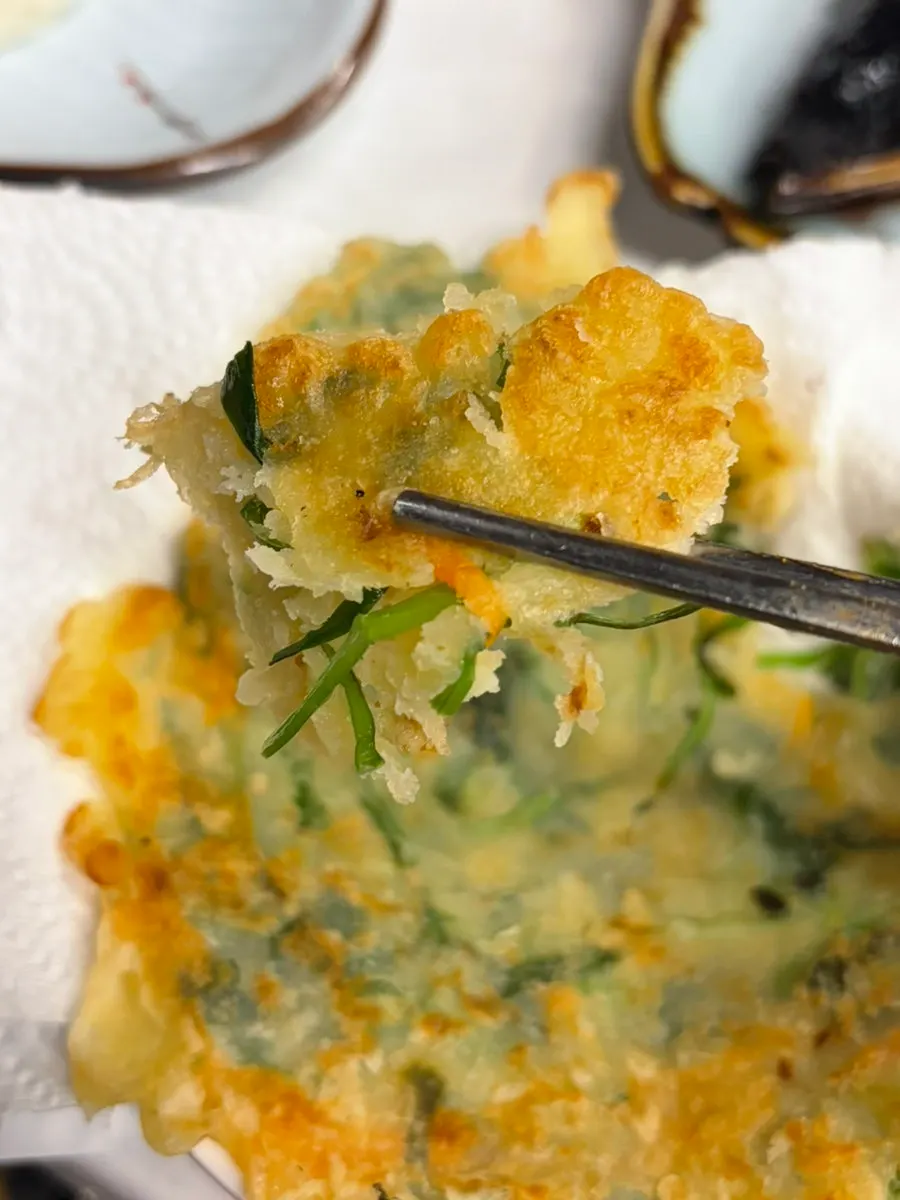 A piece of pajeon with chili inside