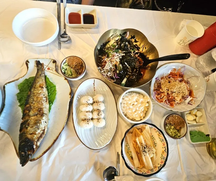 Table set with raw shrimp and raw fish sashimi for three