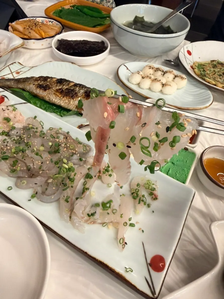 Sashimi wrapped in seaweed and white kimchi