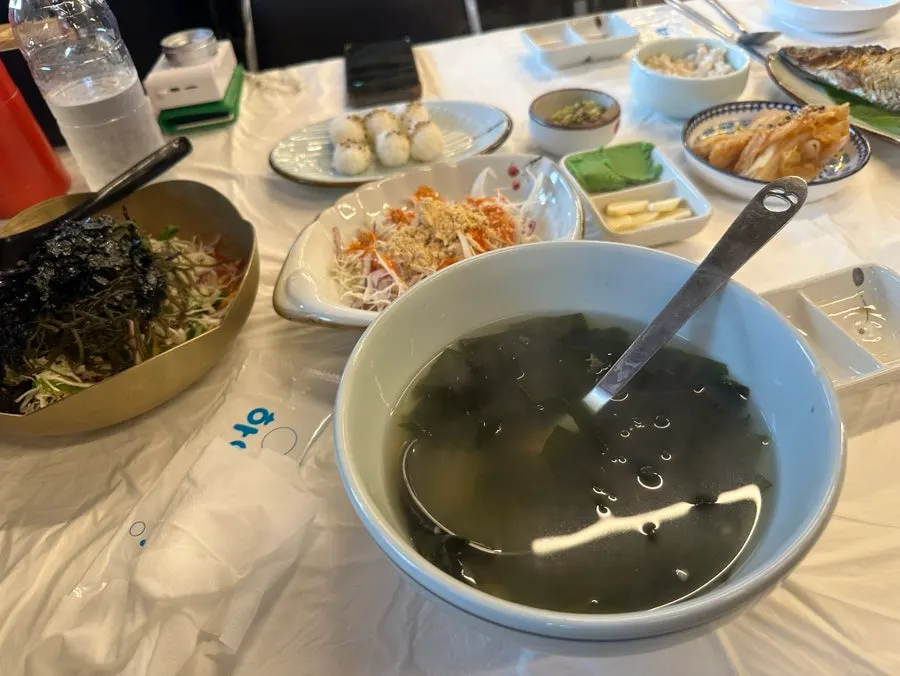 Grilled fish, sushi rice, and salad side dishes