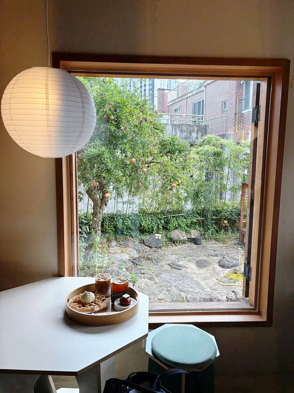 Window seat at Hoyang Horim with a view of a pomegranate tree