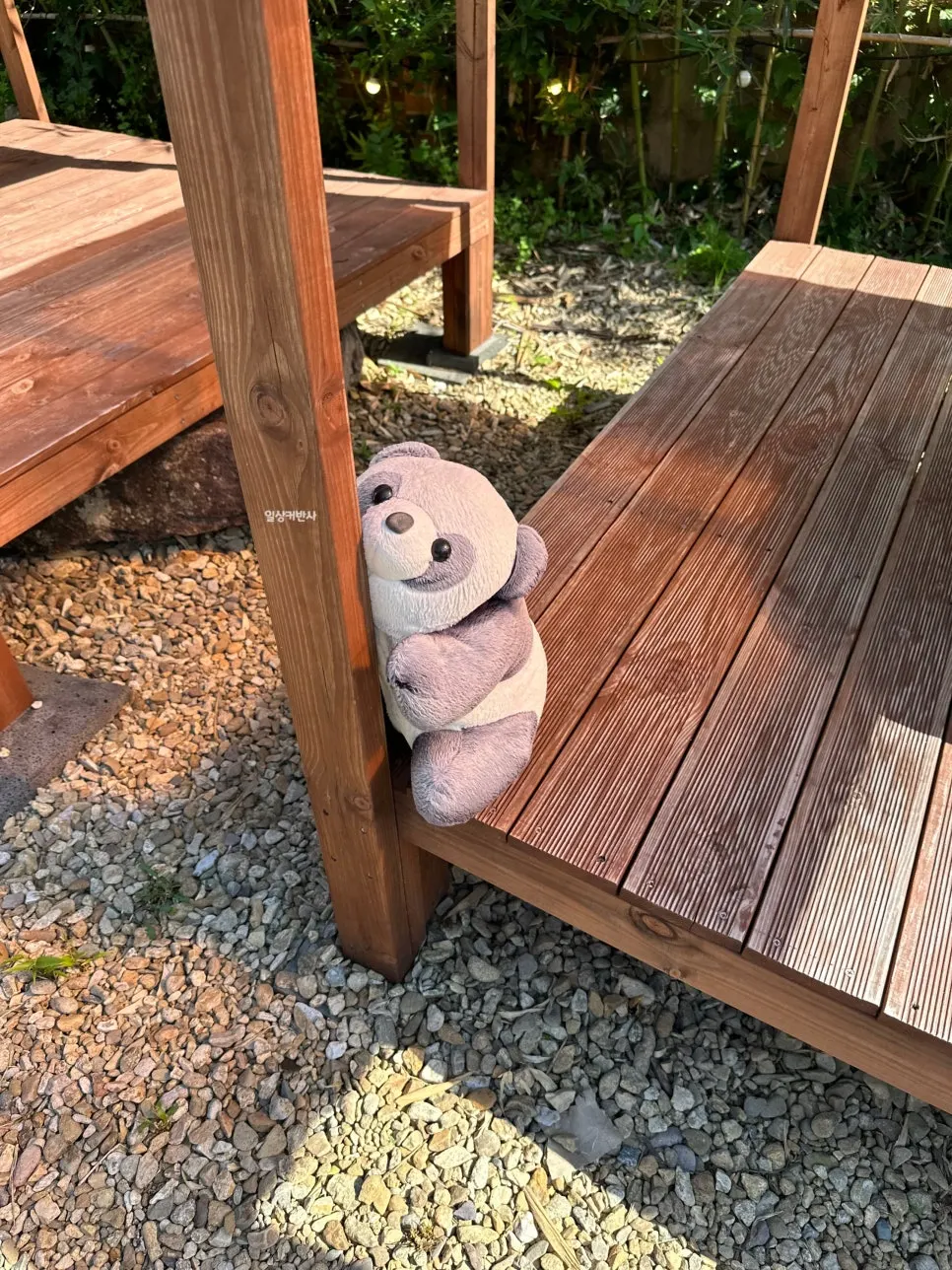 Panda doll hugging a platform post
