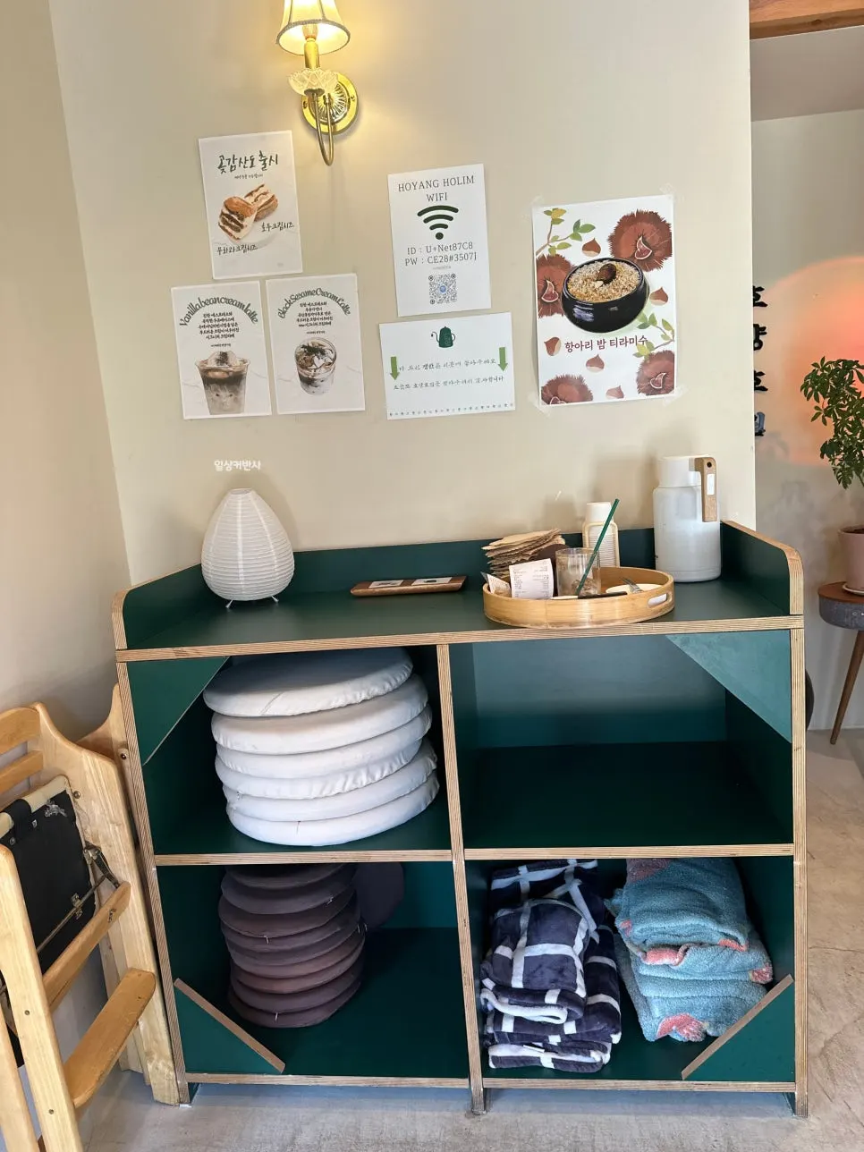 Cabinet with cushions, blankets, and a high chair