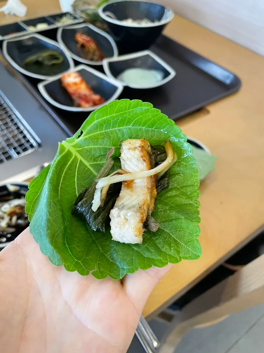 A piece of grilled eel served with ginger