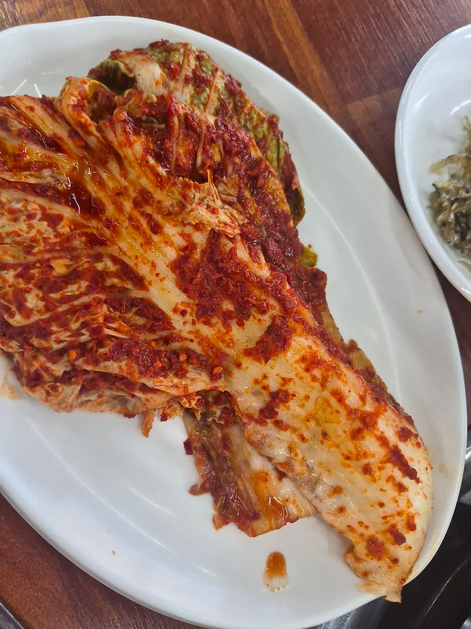 Pot with whole kimchi placed on top before mixing in