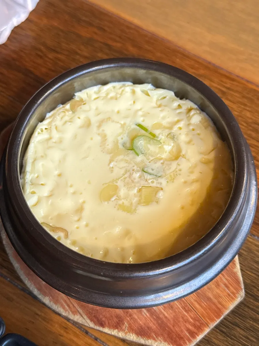 A spoonful of hot fish cake soup broth